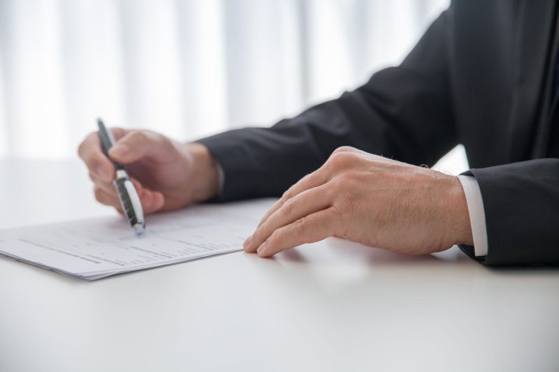 Missoula, Montana Branch 25 Businessman signing important documents at office desk 1785258602